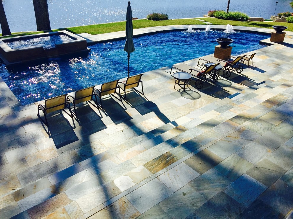 Inspiration for a large transitional backyard concrete paver and custom-shaped hot tub remodel