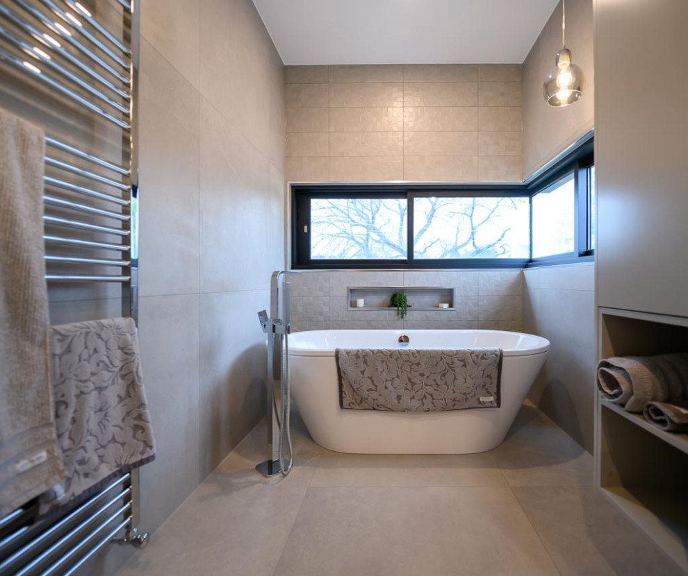 This is an example of a large wet room bathroom in Melbourne with flat-panel cabinets, grey cabinets, a freestanding bath, a wall mounted toilet, grey tiles, porcelain tiles, grey walls, porcelain flooring, grey floors, double sinks, a floating vanity unit, a submerged sink, engineered stone worktops and multi-coloured worktops.