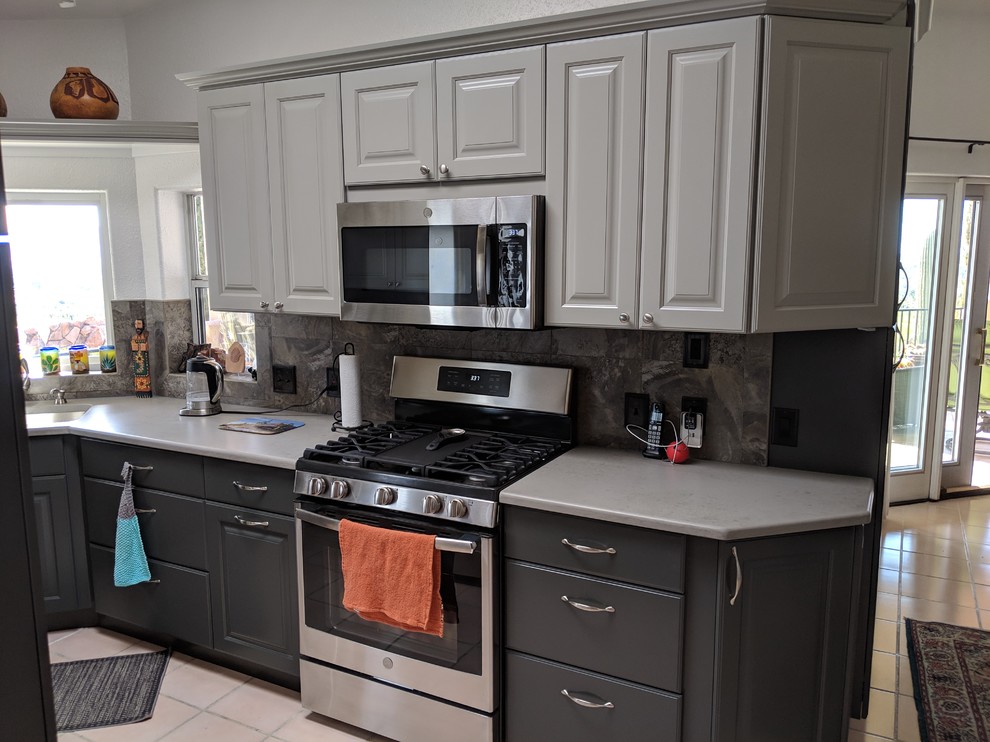 Small transitional u-shaped enclosed kitchen photo in Phoenix with raised-panel cabinets, gray cabinets, quartz countertops, slate backsplash, no island and gray countertops