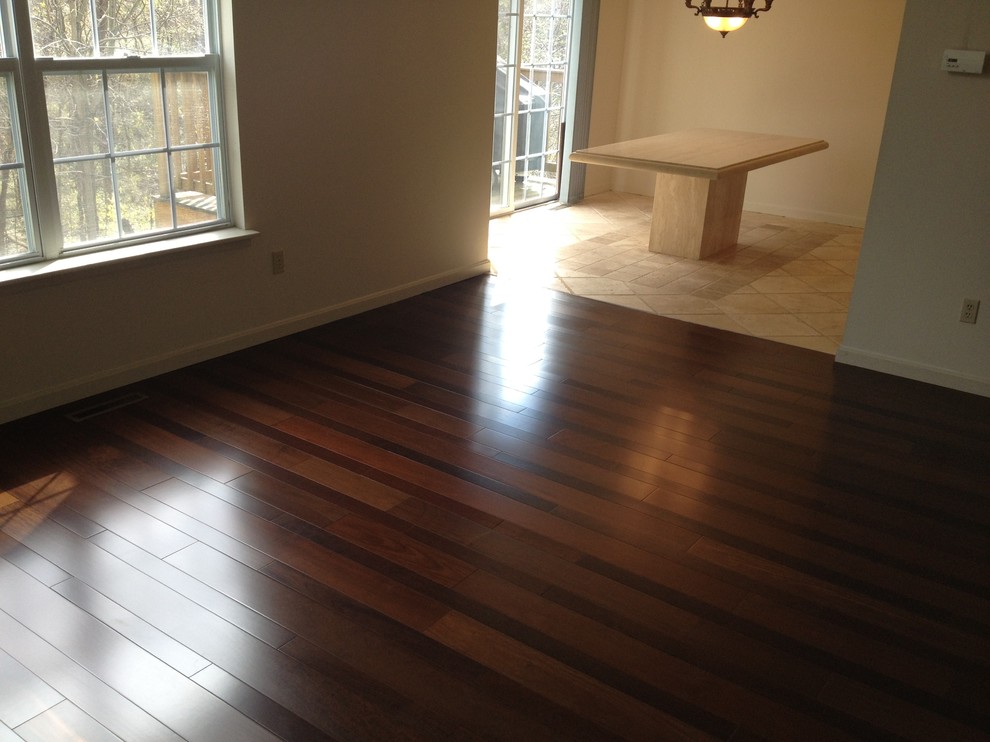 Mid-sized medium tone wood floor hallway photo with beige walls