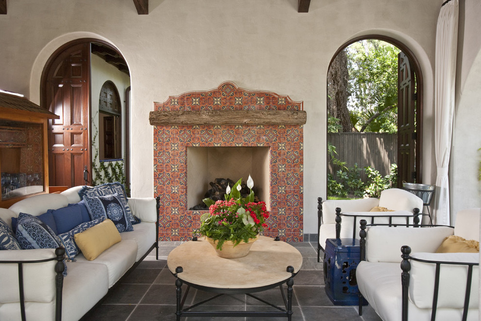 This is an example of a patio in Houston with a fire feature and tile.