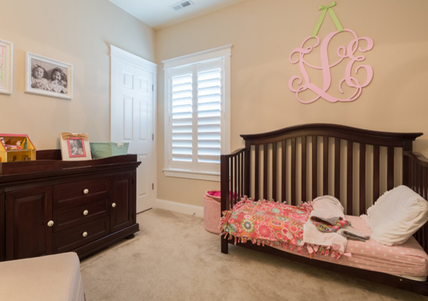 Inspiration for a mid-sized traditional nursery for girls in Denver with carpet.