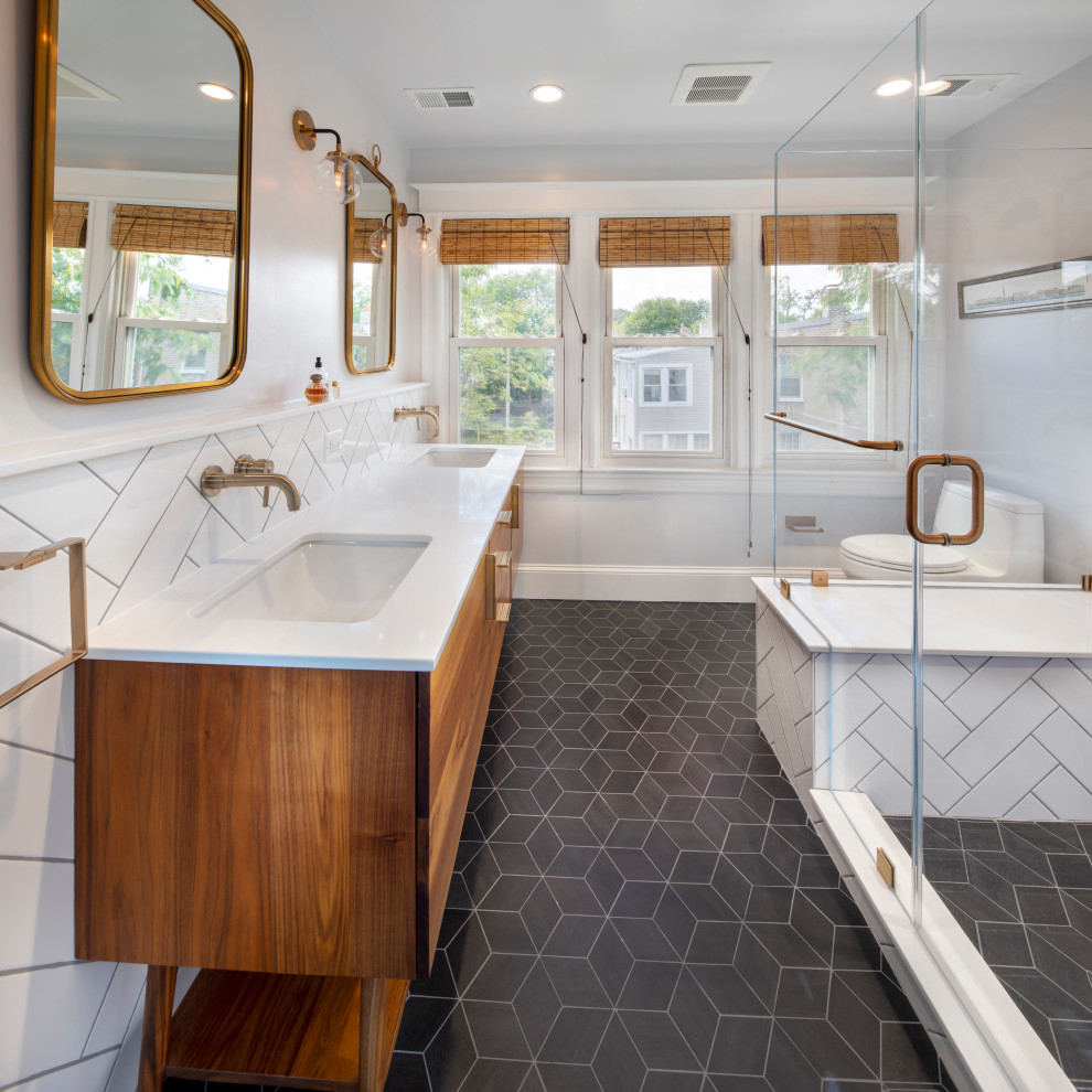 Photo of a medium sized midcentury ensuite bathroom in DC Metro with flat-panel cabinets, medium wood cabinets, a double shower, white tiles, ceramic tiles, white walls, ceramic flooring, a submerged sink, engineered stone worktops, black floors, a hinged door, white worktops, a shower bench, double sinks and a freestanding vanity unit.