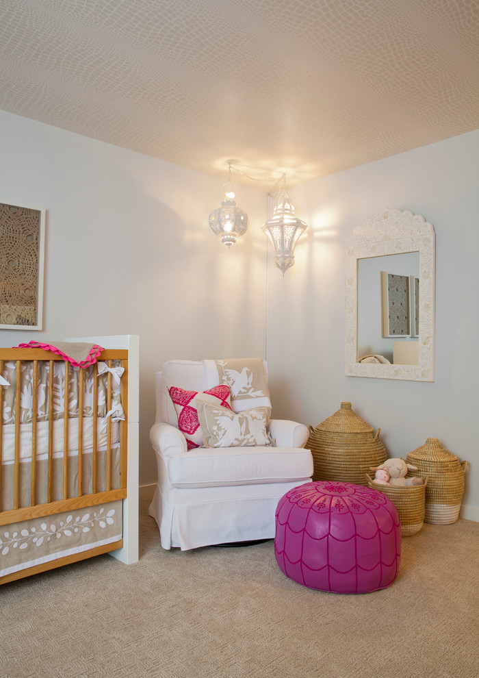 Photo of a mid-sized contemporary nursery for girls in Miami with carpet and blue walls.