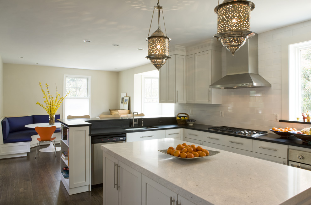 Eclectic dark wood floor eat-in kitchen photo in DC Metro with white cabinets, white backsplash, subway tile backsplash, stainless steel appliances and an island