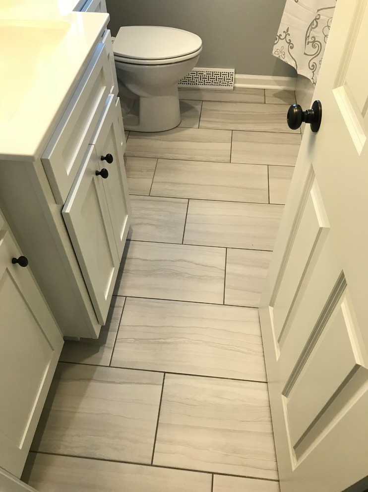 Inspiration for a mid-sized transitional home design remodel with recessed-panel cabinets, white cabinets, a one-piece toilet and white countertops