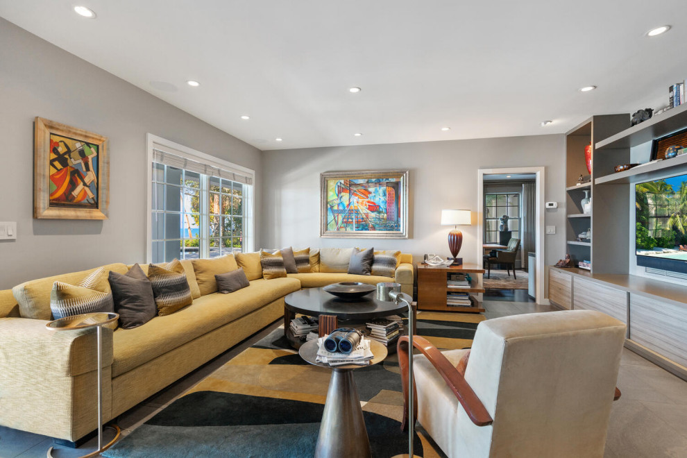 Expansive midcentury open concept family room in Tampa with grey walls, dark hardwood floors, a standard fireplace and a stone fireplace surround.