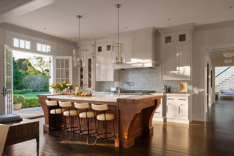 Open concept kitchen - large transitional galley dark wood floor open concept kitchen idea in New York with a single-bowl sink, recessed-panel cabinets, mosaic tile backsplash, stainless steel appliances and an island