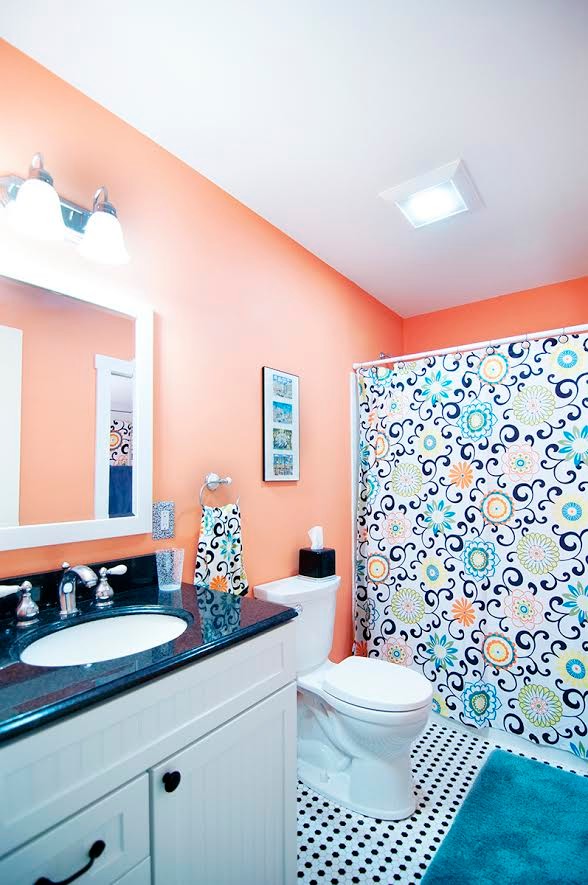 This is an example of a mid-sized contemporary kids bathroom in Boston with louvered cabinets, white cabinets, an alcove tub, a shower/bathtub combo, a one-piece toilet, orange walls, mosaic tile floors, an undermount sink, granite benchtops, white floor and a shower curtain.