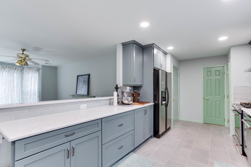 Large traditional galley kitchen/diner in DC Metro with a belfast sink, recessed-panel cabinets, blue cabinets, engineered stone countertops, cement tile splashback, stainless steel appliances and no island.