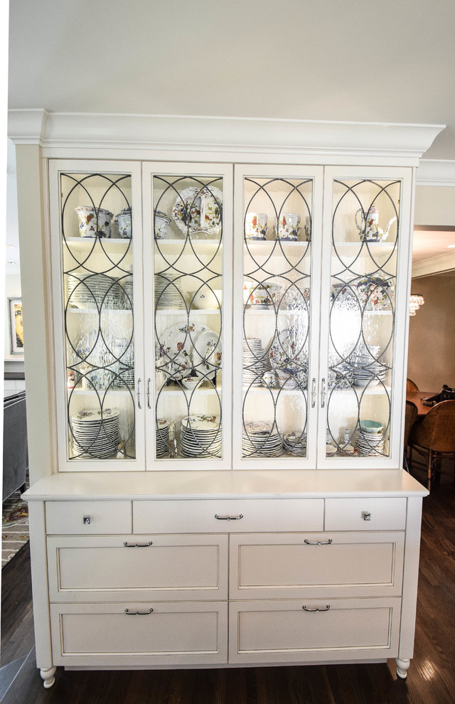 Kitchen - transitional kitchen idea in Boise with glass-front cabinets and white cabinets