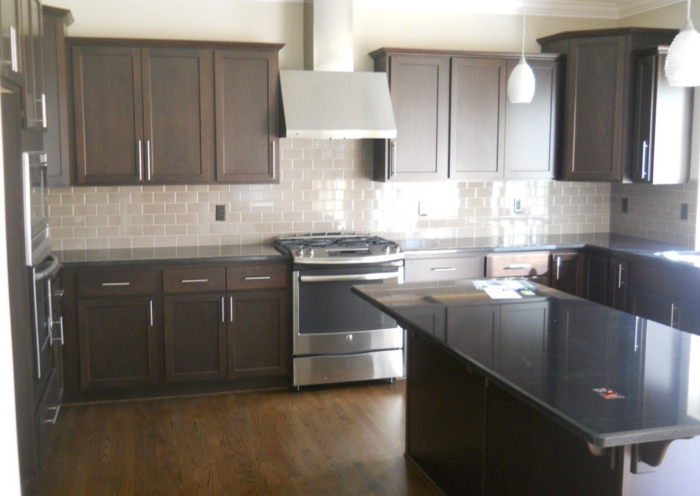 Large transitional u-shaped eat-in kitchen photo in Seattle with shaker cabinets, dark wood cabinets and an island