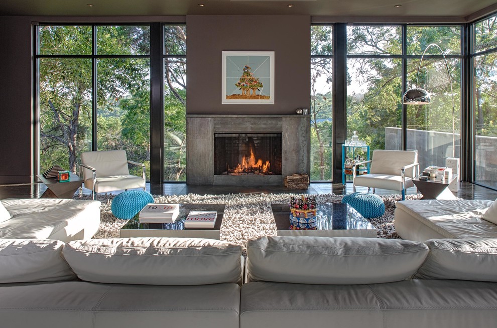 Large contemporary open concept living room in Austin with grey walls, dark hardwood floors, a standard fireplace and a concrete fireplace surround.