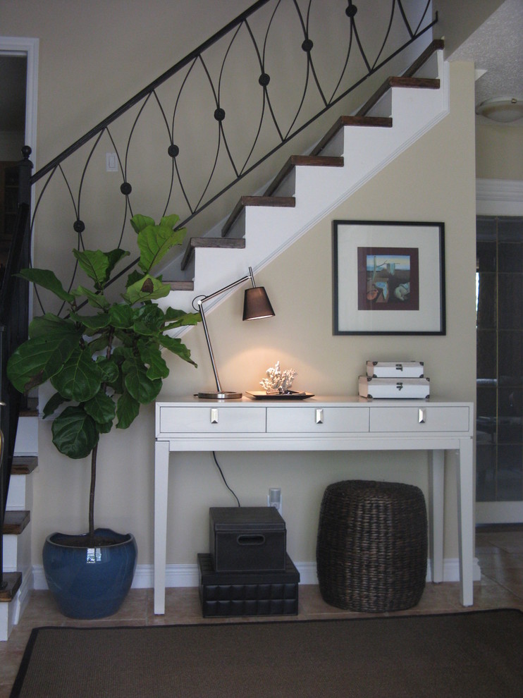 Photo of a mid-sized transitional foyer in Ottawa with beige walls and porcelain floors.