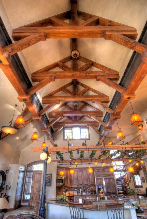 Huge mountain style u-shaped cement tile floor and gray floor open concept kitchen photo with a farmhouse sink, raised-panel cabinets, distressed cabinets, granite countertops, multicolored backsplash, stone slab backsplash, paneled appliances and an island