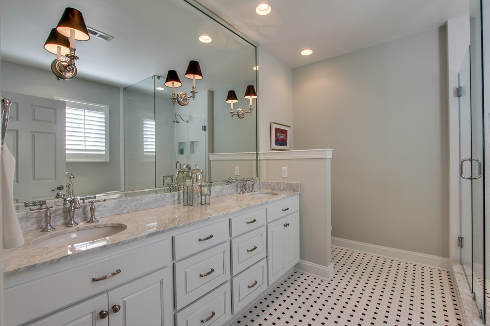 Inspiration for a mid-sized traditional bathroom in Nashville with an undermount sink, raised-panel cabinets, white cabinets, marble benchtops, a claw-foot tub, a corner shower, a two-piece toilet, white tile, subway tile, white walls and ceramic floors.