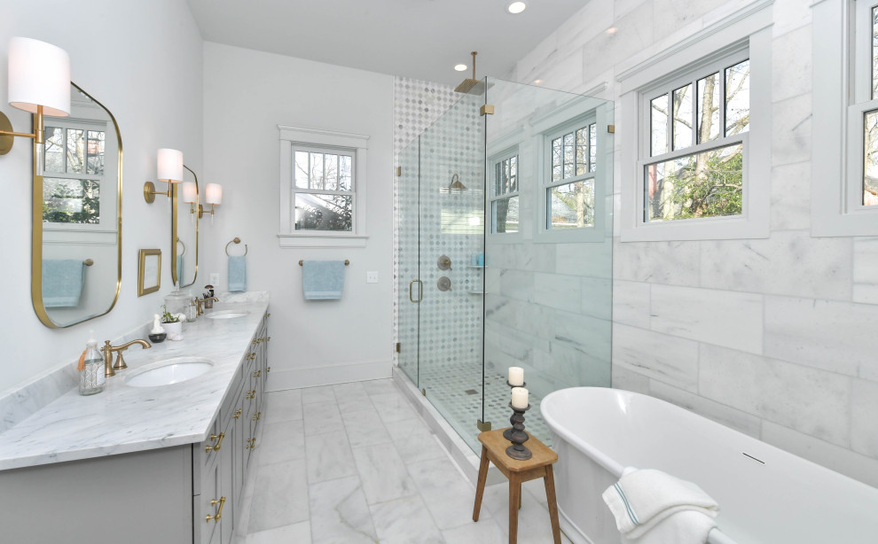 Inspiration for a large transitional master bathroom in Atlanta with shaker cabinets, grey cabinets, a freestanding tub, a corner shower, white tile, marble, white walls, marble floors, an undermount sink, marble benchtops, white floor, a hinged shower door, multi-coloured benchtops, a double vanity and a built-in vanity.