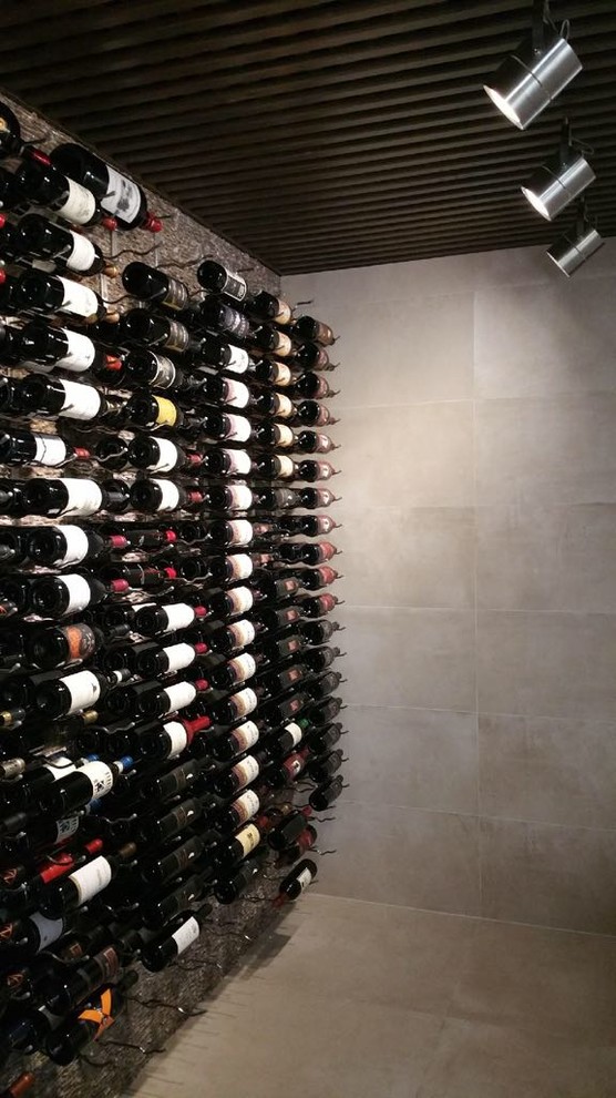 Large contemporary wine cellar in Miami with marble floors, display racks and white floor.