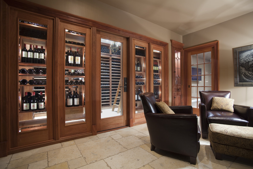 Large traditional wine cellar in Philadelphia with display racks and travertine floors.