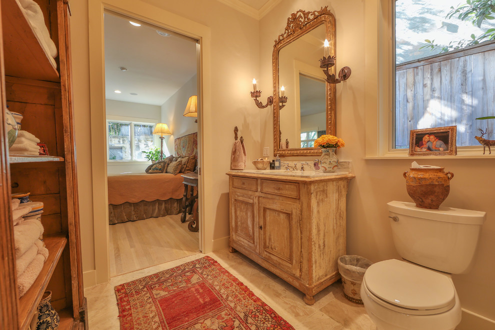 Inspiration for a mid-sized modern master bathroom in Austin with beige floor, shaker cabinets, distressed cabinets, beige walls, marble floors, an undermount sink, a freestanding tub, an open shower, white tile, beige tile, gray tile, marble, marble benchtops, an open shower and a two-piece toilet.