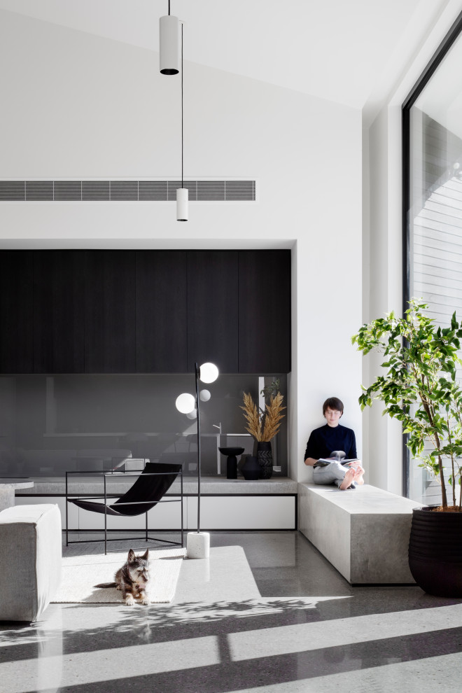 Imagen de salón minimalista con suelo de cemento