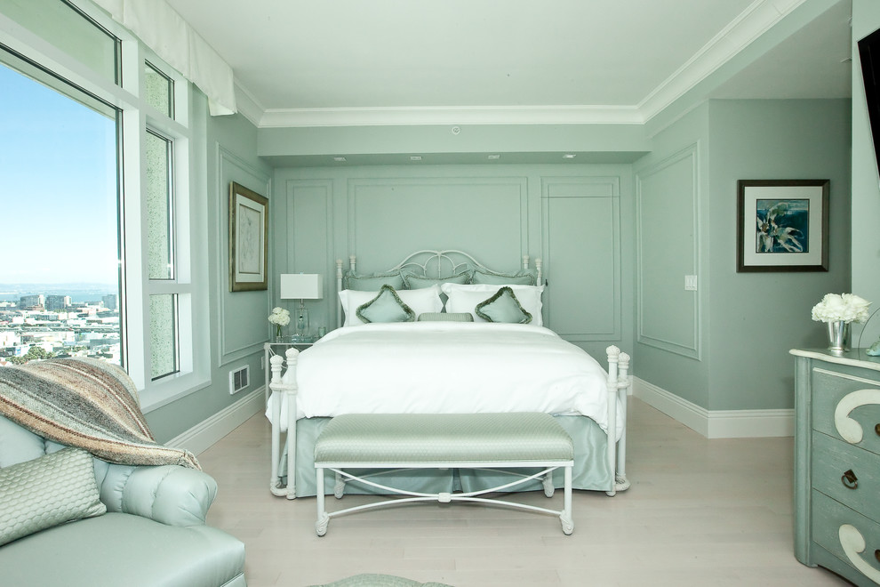 This is an example of a mid-sized transitional master bedroom in San Francisco with green walls, light hardwood floors, no fireplace and grey floor.