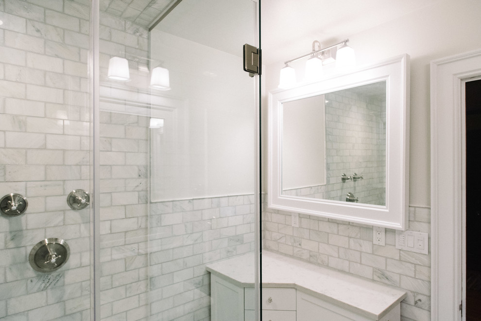 Example of a mid-sized transitional 3/4 gray tile and subway tile marble floor and gray floor double shower design with quartz countertops, a hinged shower door, shaker cabinets, white cabinets and gray walls