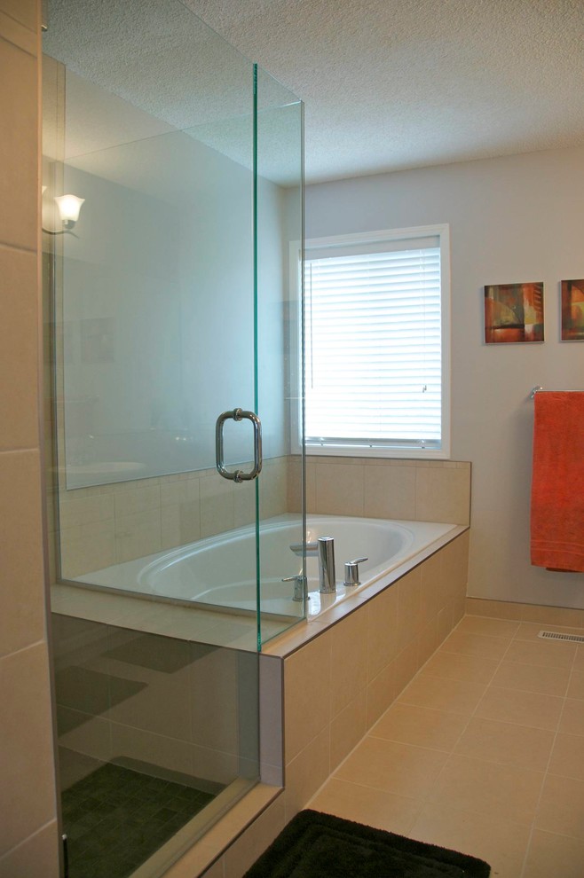 This is an example of a mid-sized contemporary master bathroom in Perth with a drop-in sink, shaker cabinets, white cabinets, laminate benchtops, a drop-in tub, a corner shower, a one-piece toilet, beige tile, ceramic tile, grey walls and ceramic floors.