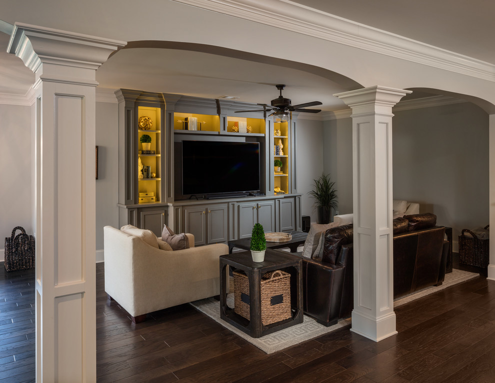 Photo of a large traditional walk-out basement in Atlanta with grey walls, dark hardwood floors, a standard fireplace, a stone fireplace surround and brown floor.