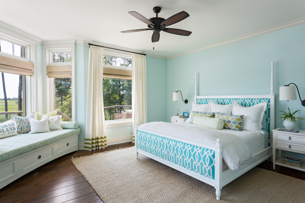 Beach style bedroom in Charleston with blue walls, dark hardwood floors and brown floor.
