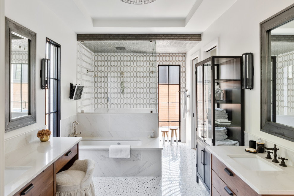 This is an example of a mid-sized transitional master bathroom in Dallas with flat-panel cabinets, medium wood cabinets, an undermount tub, a two-piece toilet, white tile, multi-coloured floor, a sliding shower screen, beige benchtops, a double vanity, a built-in vanity, a double shower, white walls and an undermount sink.