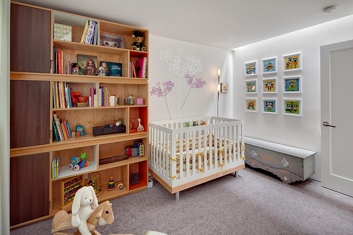 Inspiration for a small modern nursery for girls in Seattle with white walls and carpet.