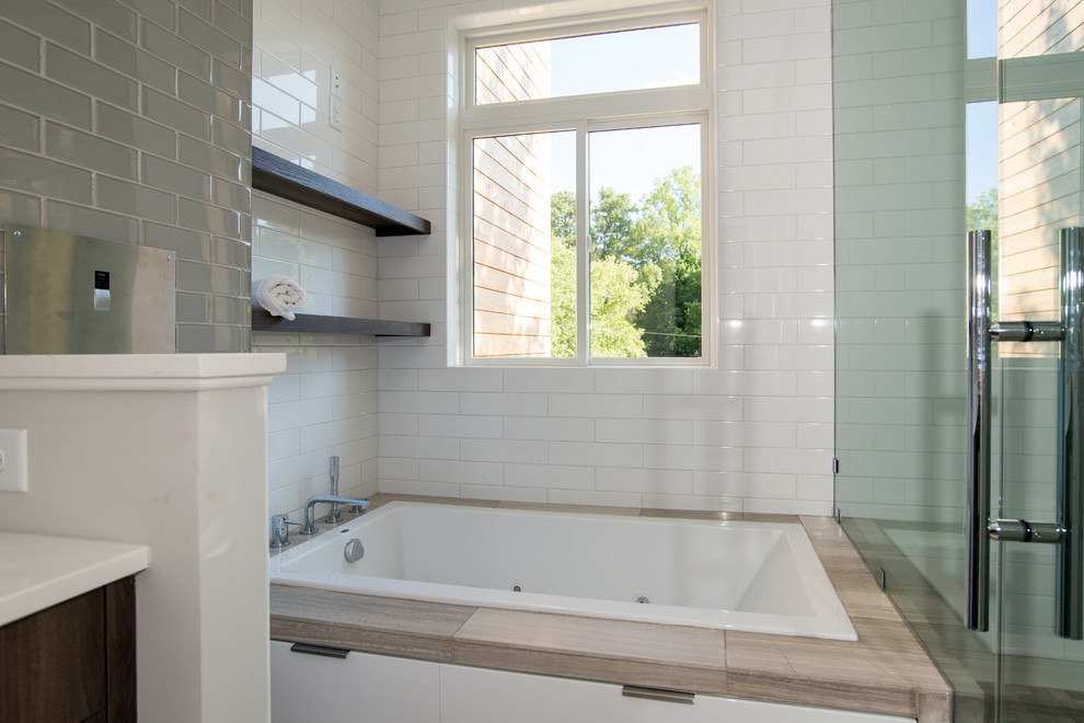 Photo of a mid-sized modern bathroom in Atlanta with flat-panel cabinets, brown cabinets, a hot tub, a two-piece toilet, beige tile, glass tile, grey walls, limestone floors, an undermount sink, engineered quartz benchtops and with a sauna.
