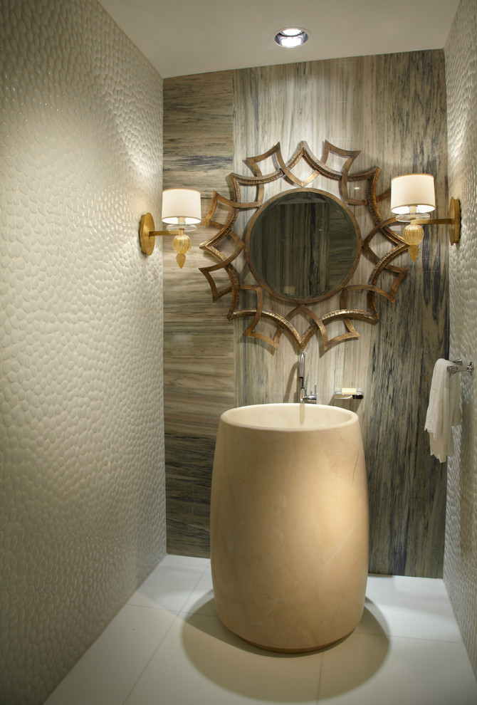 Inspiration for a mid-sized contemporary powder room in Miami with a pedestal sink, white tile, beige tile, pebble tile, marble floors and beige walls.