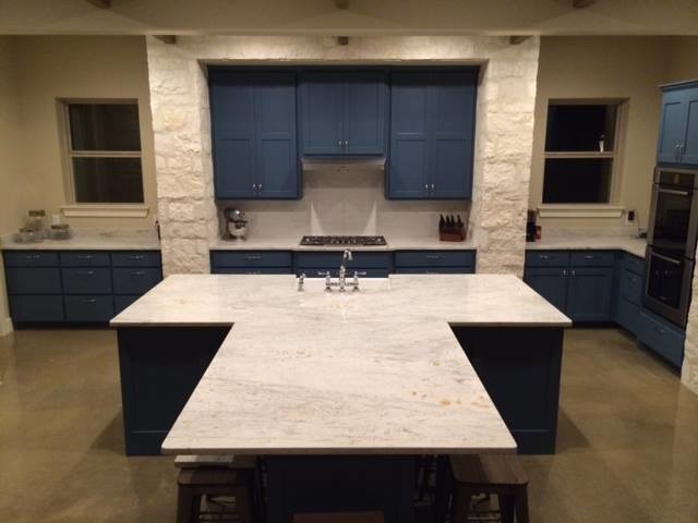Inspiration for a large transitional u-shaped concrete floor and brown floor open concept kitchen remodel in Austin with a farmhouse sink, recessed-panel cabinets, blue cabinets, quartz countertops, stainless steel appliances, an island and white countertops