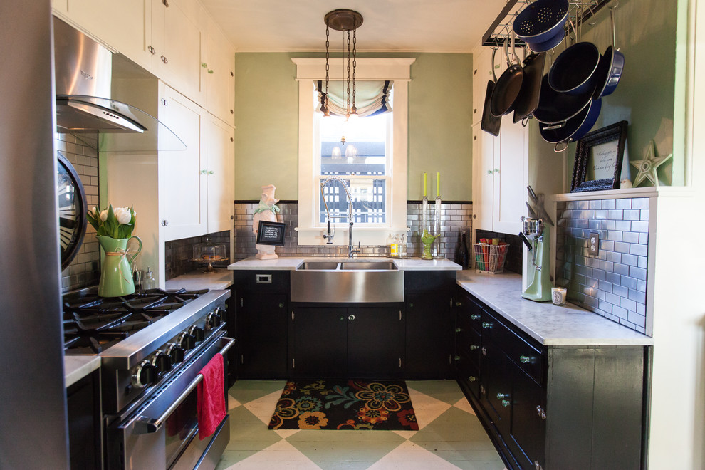 Design ideas for a small industrial u-shaped separate kitchen in Seattle with a farmhouse sink, shaker cabinets, black cabinets, marble benchtops, metallic splashback, stainless steel appliances, painted wood floors, no island, subway tile splashback, grey benchtop and green floor.