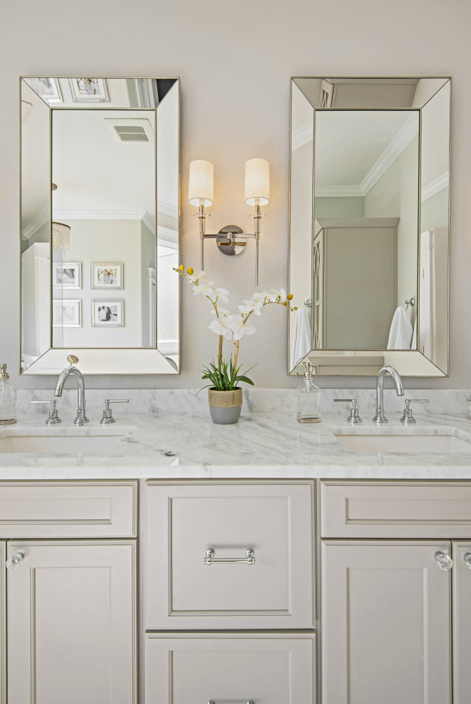 This is an example of a large traditional master bathroom in Tampa with flat-panel cabinets, beige cabinets, a hot tub, a corner shower, a one-piece toilet, gray tile, marble, beige walls, marble floors, an undermount sink, engineered quartz benchtops, white floor, a sliding shower screen, white benchtops, a niche, a double vanity and a built-in vanity.