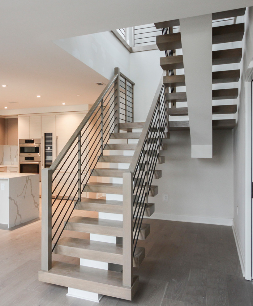 Inspiration for a large contemporary wood u-shaped staircase in DC Metro with cable railing.