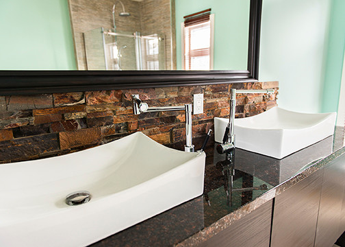 This is an example of a large eclectic master bathroom in Other with a vessel sink, flat-panel cabinets, dark wood cabinets, granite benchtops, stone slab, green walls and porcelain floors.