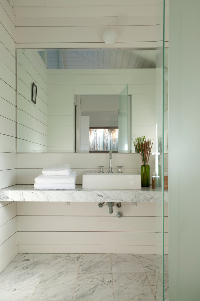 This is an example of a beach style bathroom in Other with marble benchtops and a vessel sink.