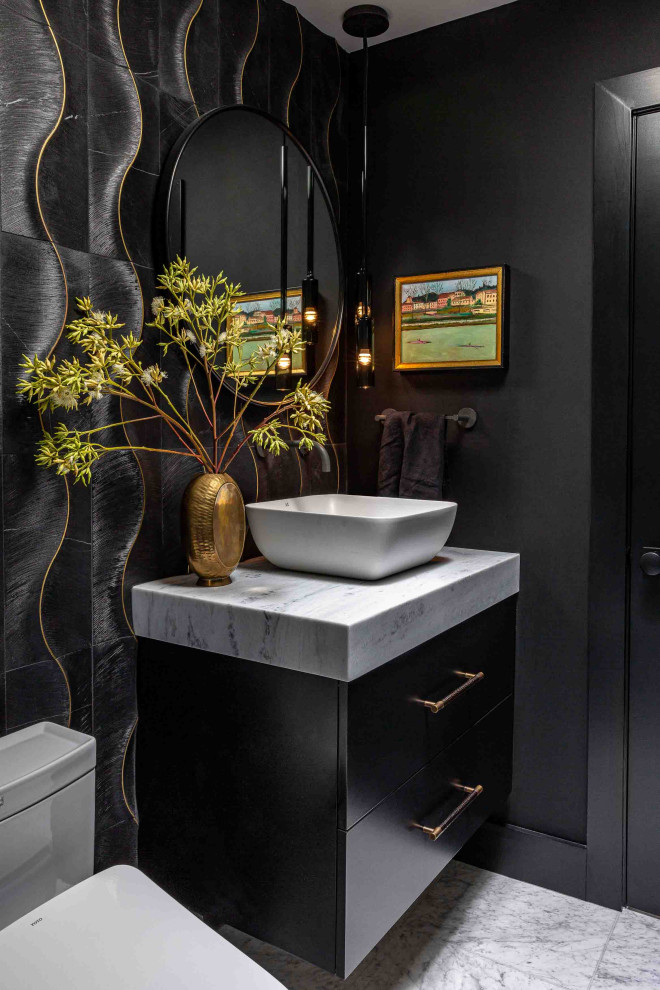 This is an example of a contemporary bathroom in San Francisco with flat-panel cabinets, black cabinets, a wall-mount toilet, black tile, black walls, marble floors, a vessel sink, marble benchtops, white floor, a hinged shower door, white benchtops, a single vanity and a floating vanity.