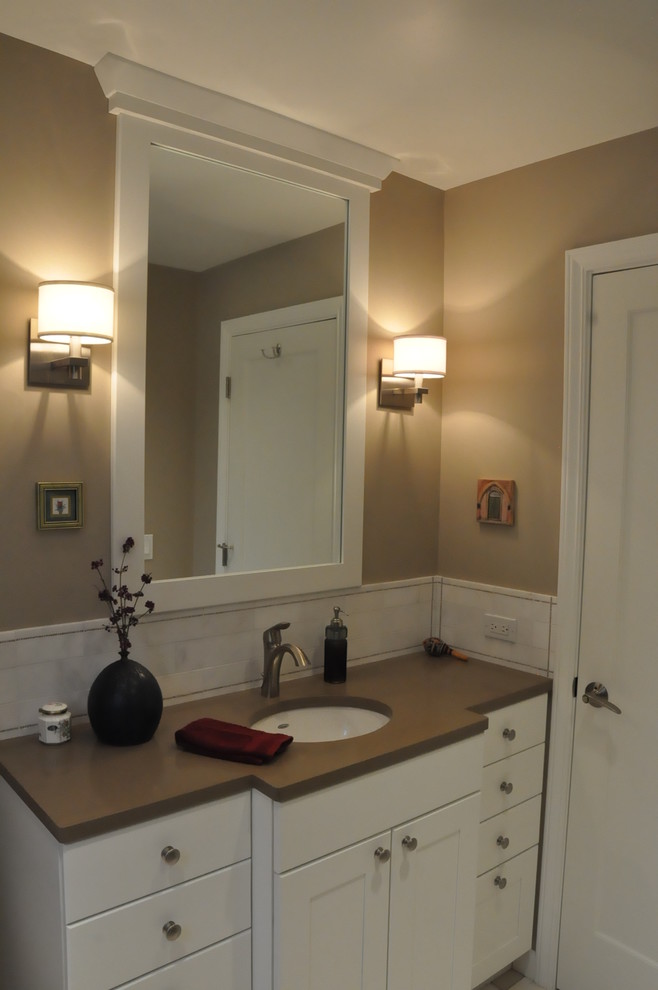 Example of a small transitional 3/4 beige tile and ceramic tile porcelain tile corner shower design in Seattle with an undermount sink, recessed-panel cabinets, white cabinets, quartzite countertops, a two-piece toilet and brown walls