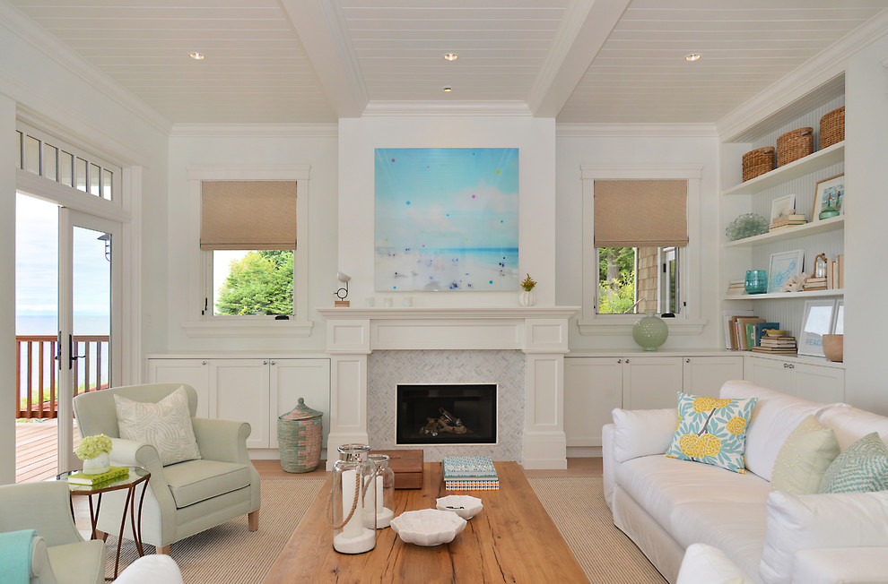 This is an example of a beach style formal living room in Vancouver with white walls, light hardwood floors, a ribbon fireplace and a tile fireplace surround.