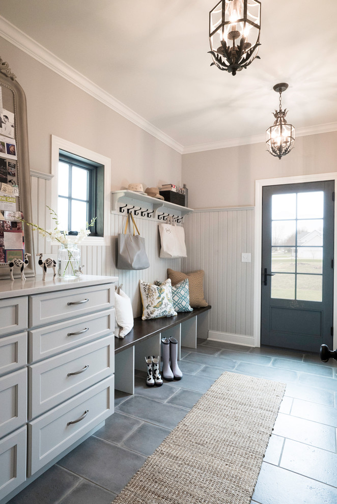 Inspiration for a mid-sized country mudroom in St Louis with beige walls, porcelain floors, grey floor, a single front door and a gray front door.