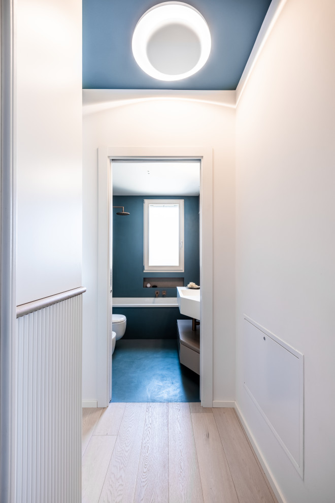 Esempio di una piccola camera matrimoniale moderna con pareti blu, parquet chiaro e pavimento beige