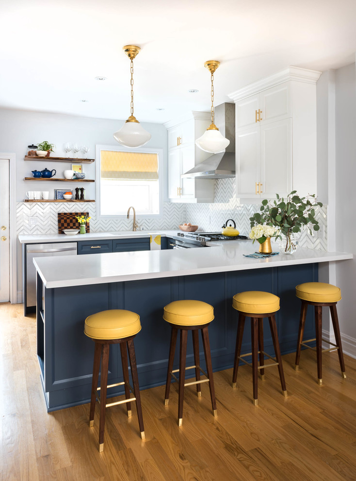 Inspiration for a transitional u-shaped open plan kitchen in Toronto with an undermount sink, recessed-panel cabinets, white cabinets, quartz benchtops, white splashback, stainless steel appliances, light hardwood floors, a peninsula and beige floor.