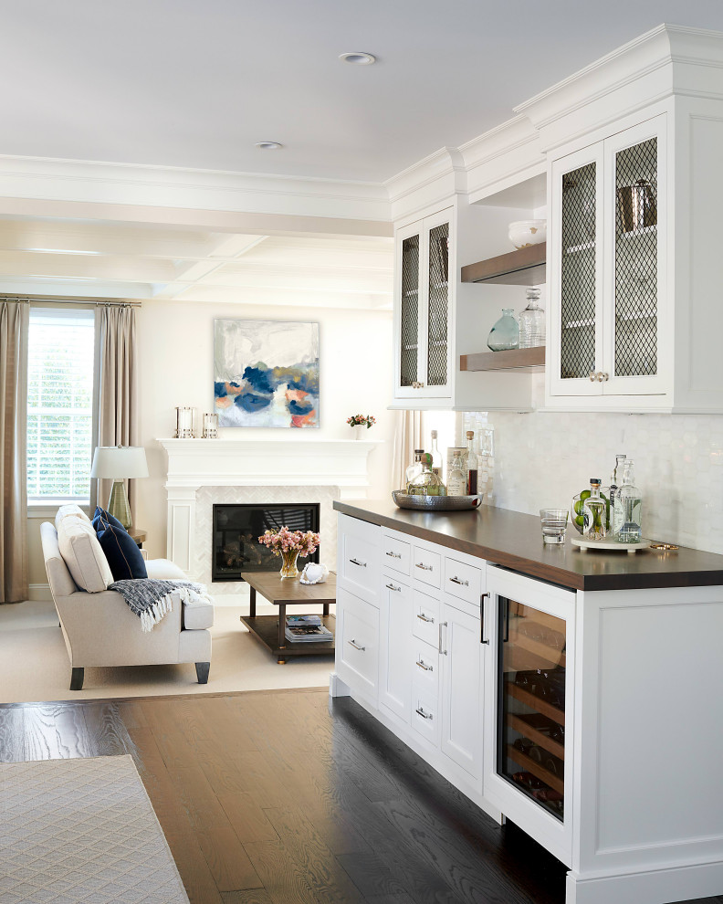 This is an example of a classic dry bar in Philadelphia with wood worktops, white splashback and dark hardwood flooring.