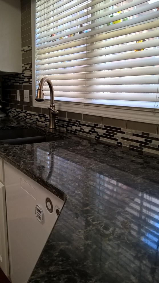 Inspiration for a transitional kitchen remodel with a double-bowl sink, raised-panel cabinets, white cabinets, granite countertops, multicolored backsplash, glass tile backsplash and stainless steel appliances