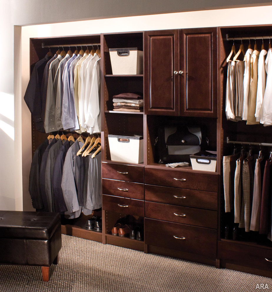 Design ideas for a large traditional gender-neutral walk-in wardrobe in Minneapolis with flat-panel cabinets, dark wood cabinets and carpet.