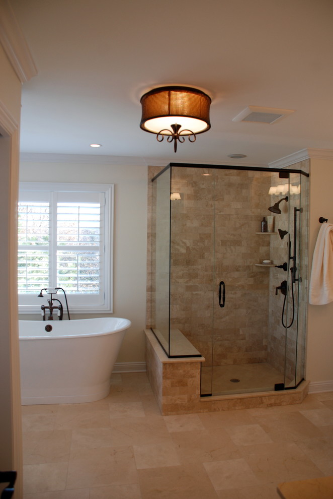 Mid-sized traditional master bathroom in Chicago with an undermount sink, recessed-panel cabinets, white cabinets, marble benchtops, a freestanding tub, an open shower, a two-piece toilet, beige tile, stone tile, beige walls and marble floors.